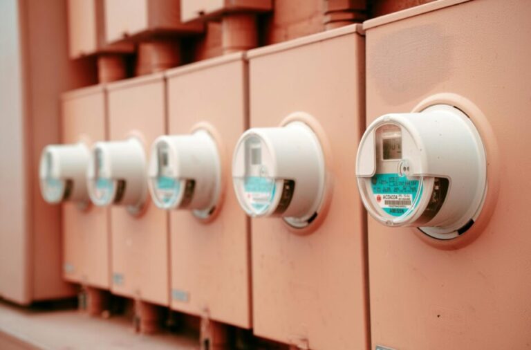 Close-up view of a row of industrial electricity meters for power monitoring and technology.